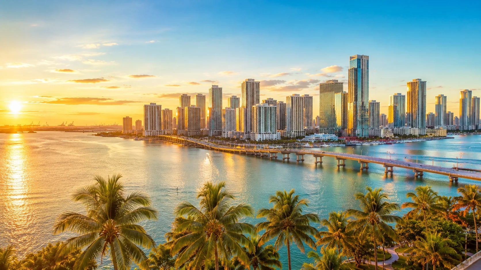 Miami skyline at sunset over Biscayne Bay with downtown Brickell towers and palm trees