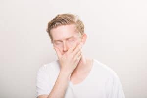 frustrated-blonde-man-white-background