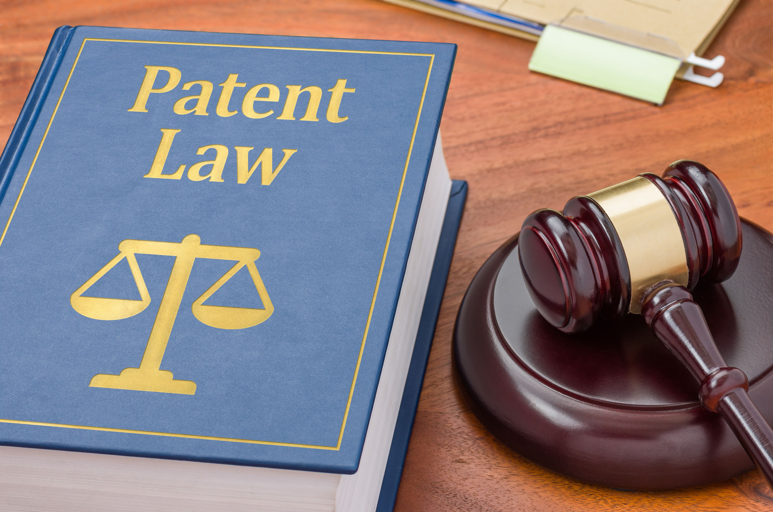 patent law book beside wooden hammer and gavel
