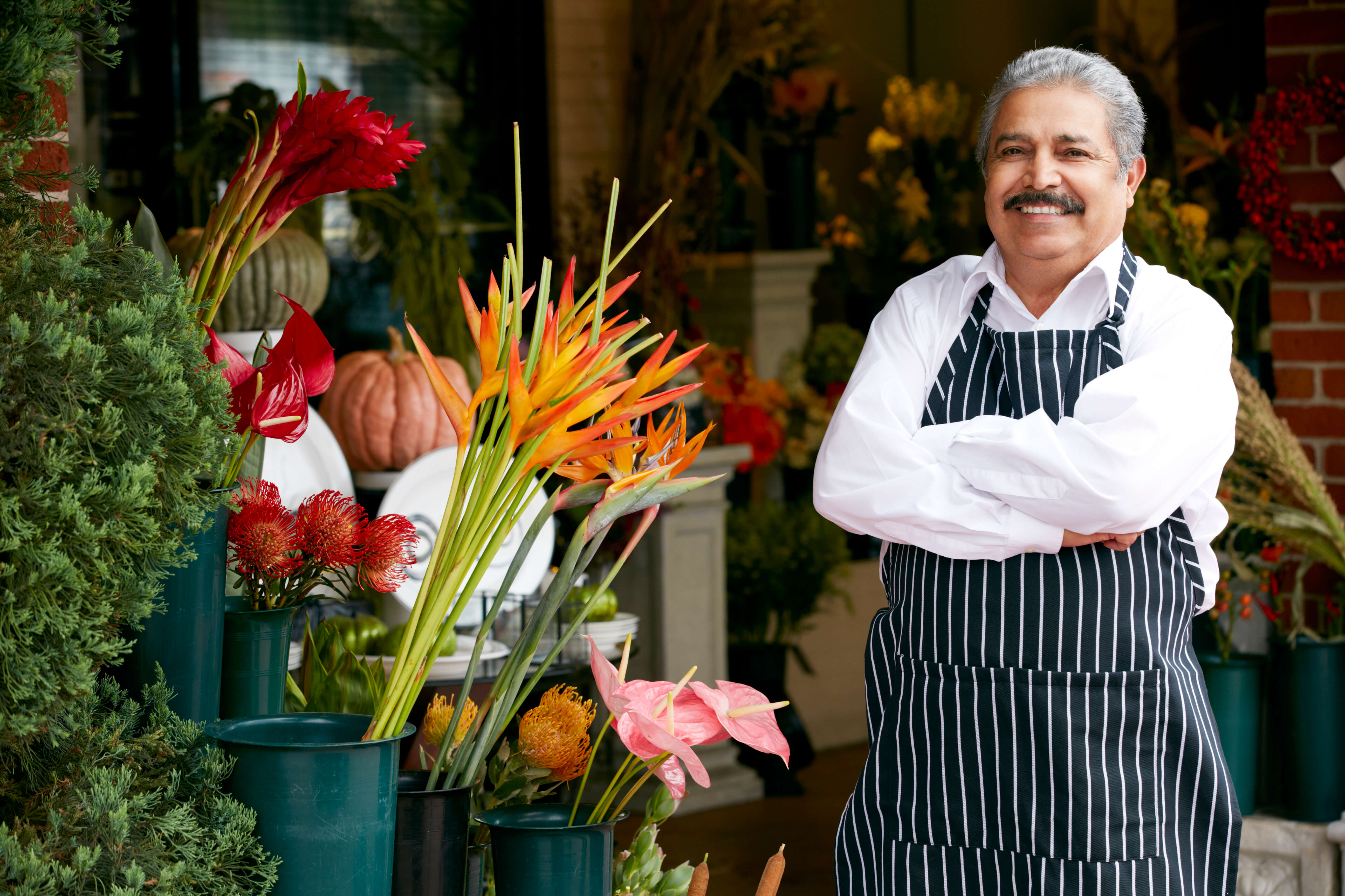 small business owner standing outside his flower shop