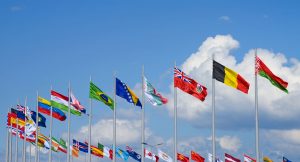 Row of national flags against blue sky