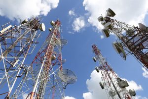 Telecommunication tower with blue sky and cloud