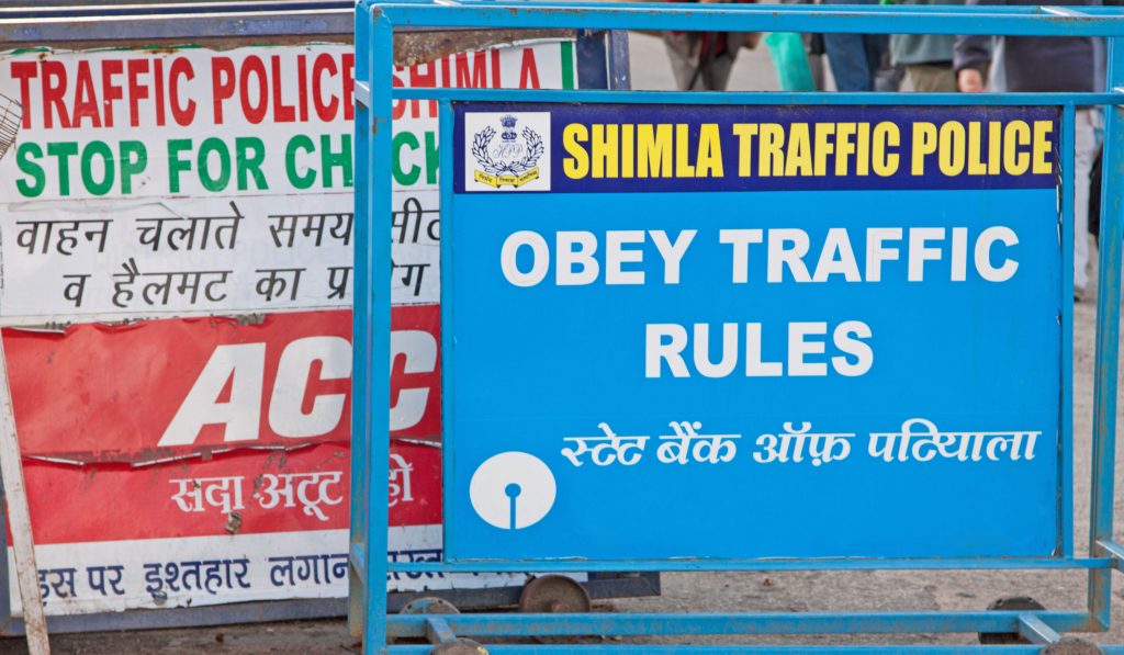 Traffic police signage in English and Hindi giving instructions to drivers in Shimla, northern India