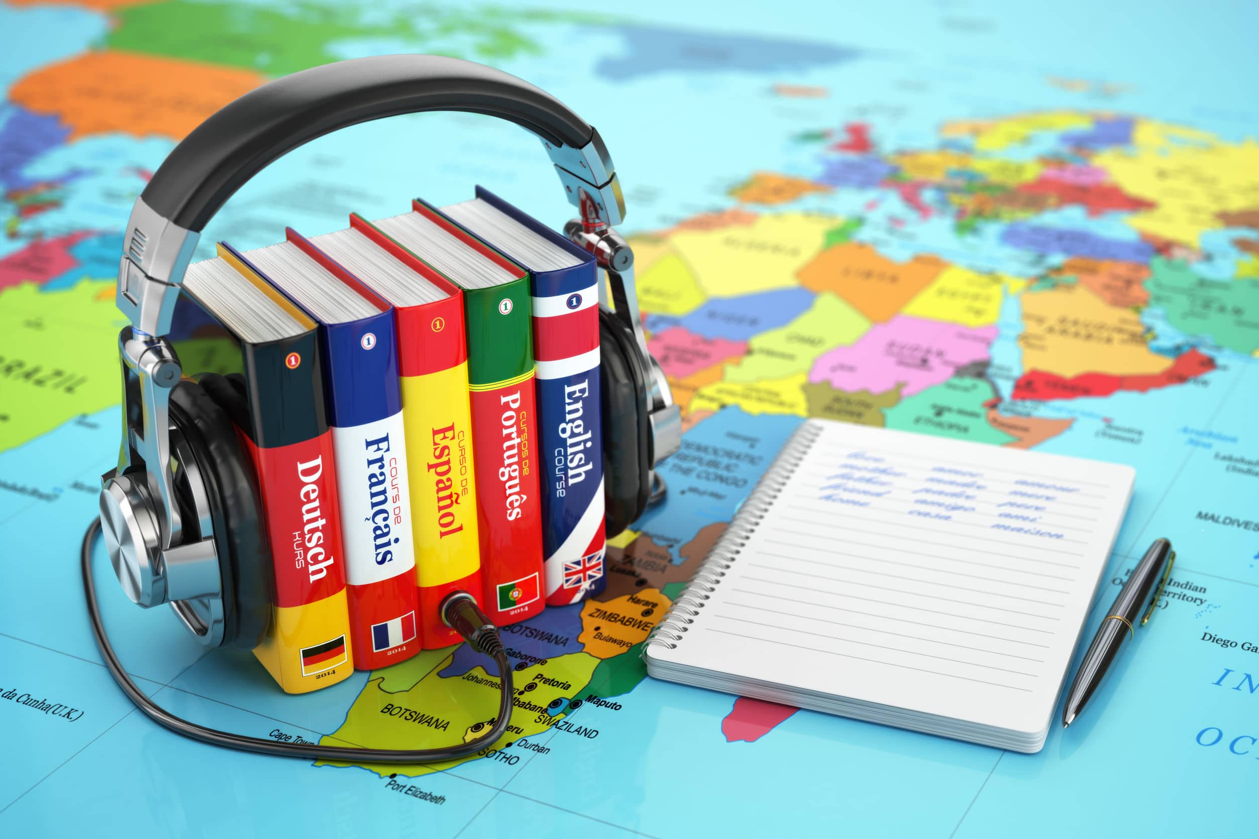 language books bound by a headphone and notebook over a map