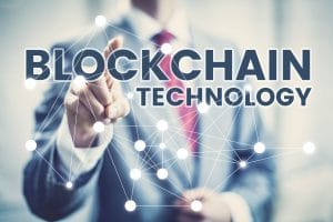 businessman pressing a dot on a blockchain technology banner