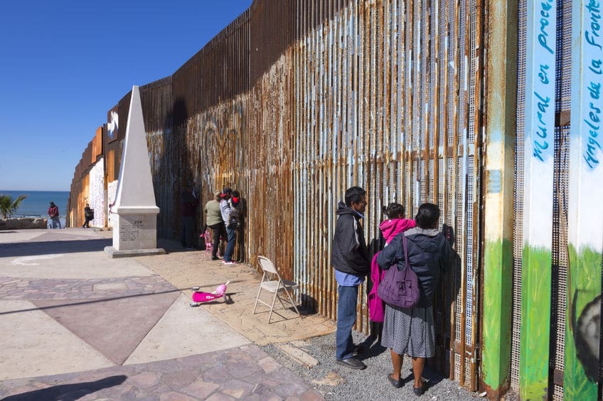 Mexican families meet at the border wall in Playas de Tijuana
