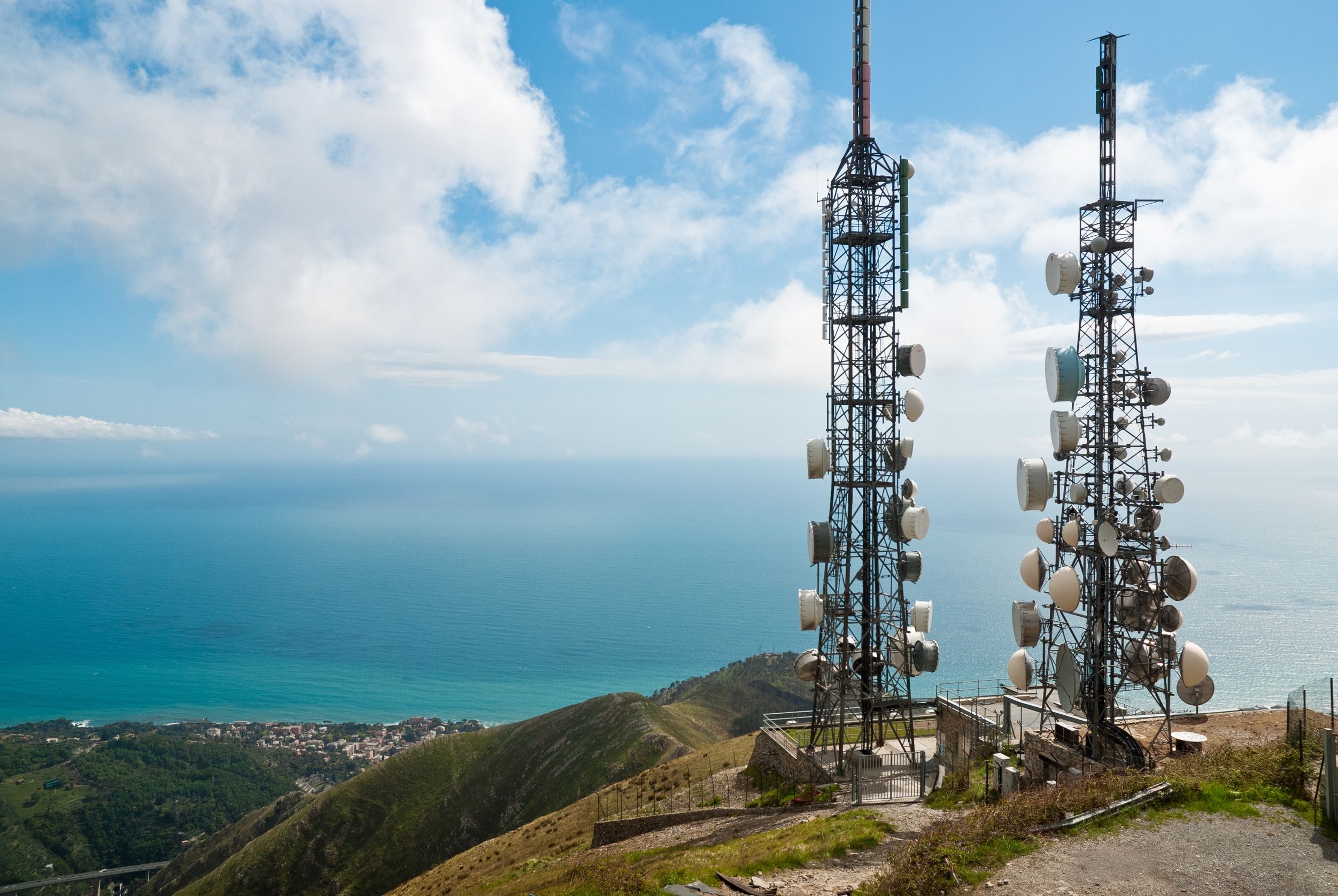 aerial view of two telecommunications towers on top of a mountain