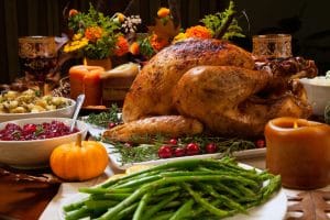 sumptuous thanksgiving dinner highlighted by a roasted turkey garnished with cranberries