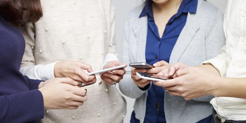 group of people using cellphones