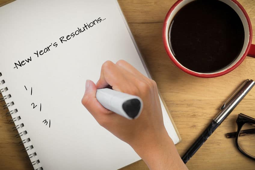 making a list of new years resolution while having coffee