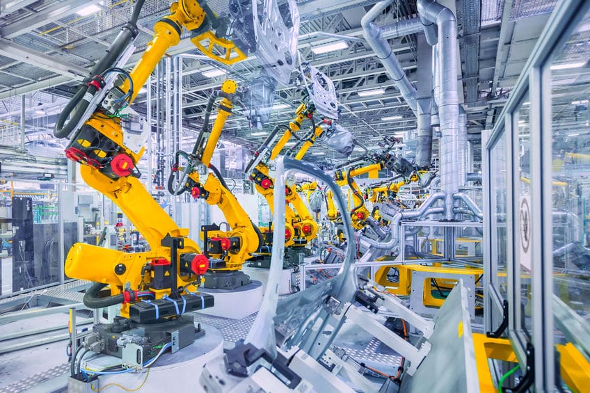 robotic arms in a car plant manufacturing industry