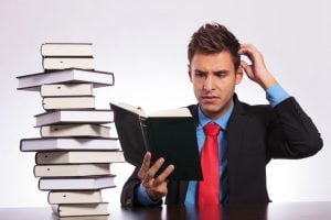 business man confused reading English words