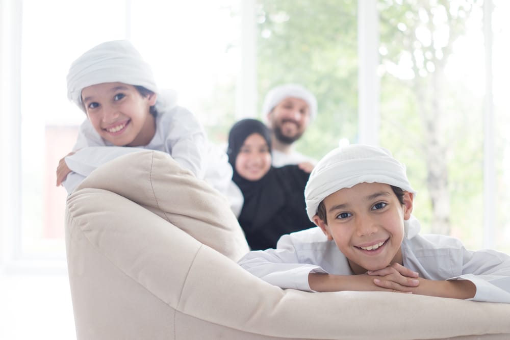 modern Arabian family having fun on their couch