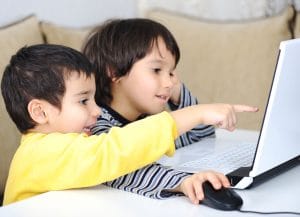 Children using laptop to play games