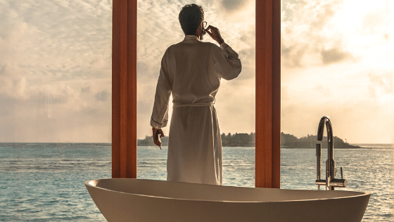 man-standing-besides-bathtub-caribbean-scenery