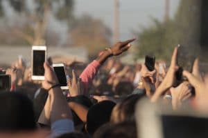 people with phones in air