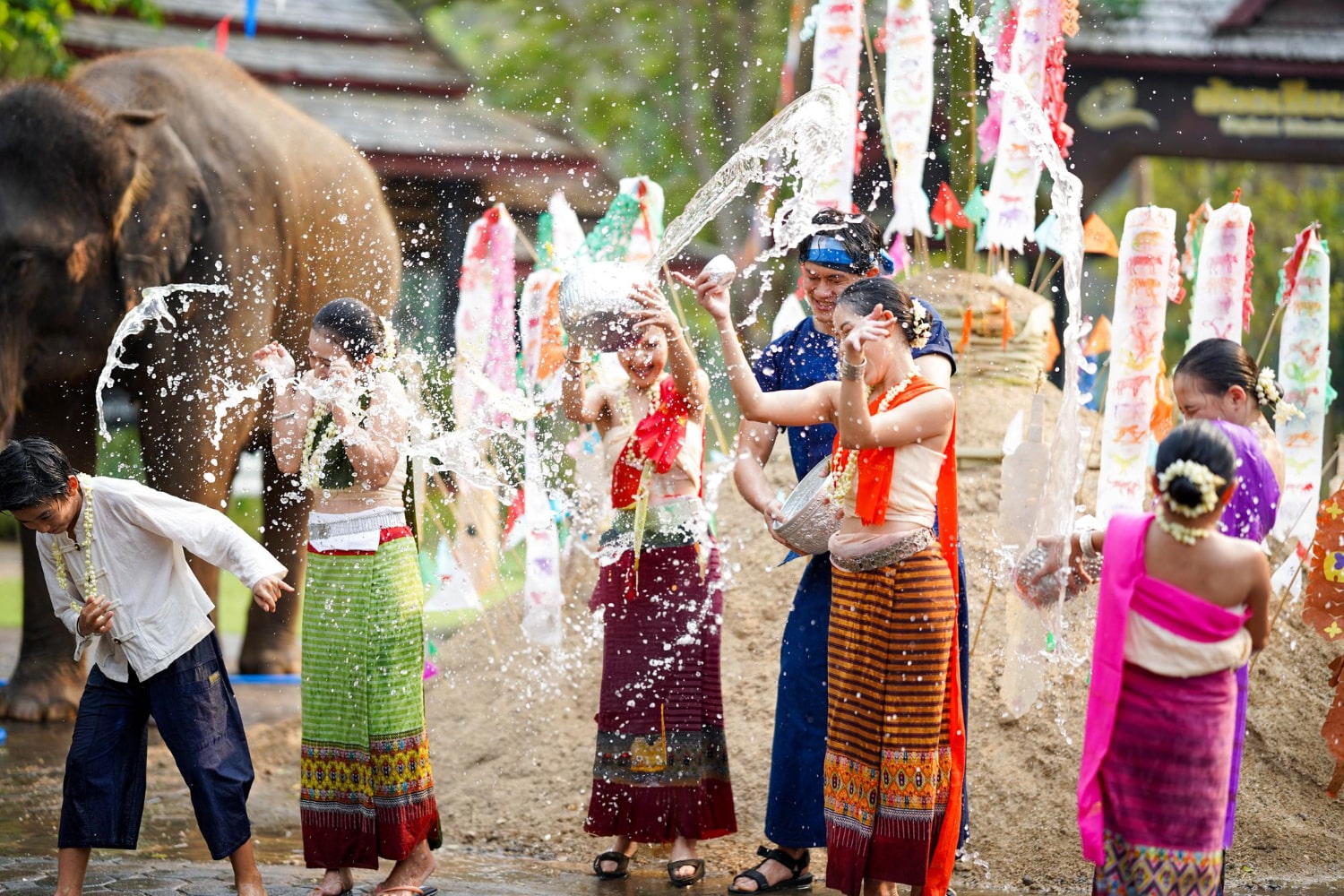 People pour water on each other