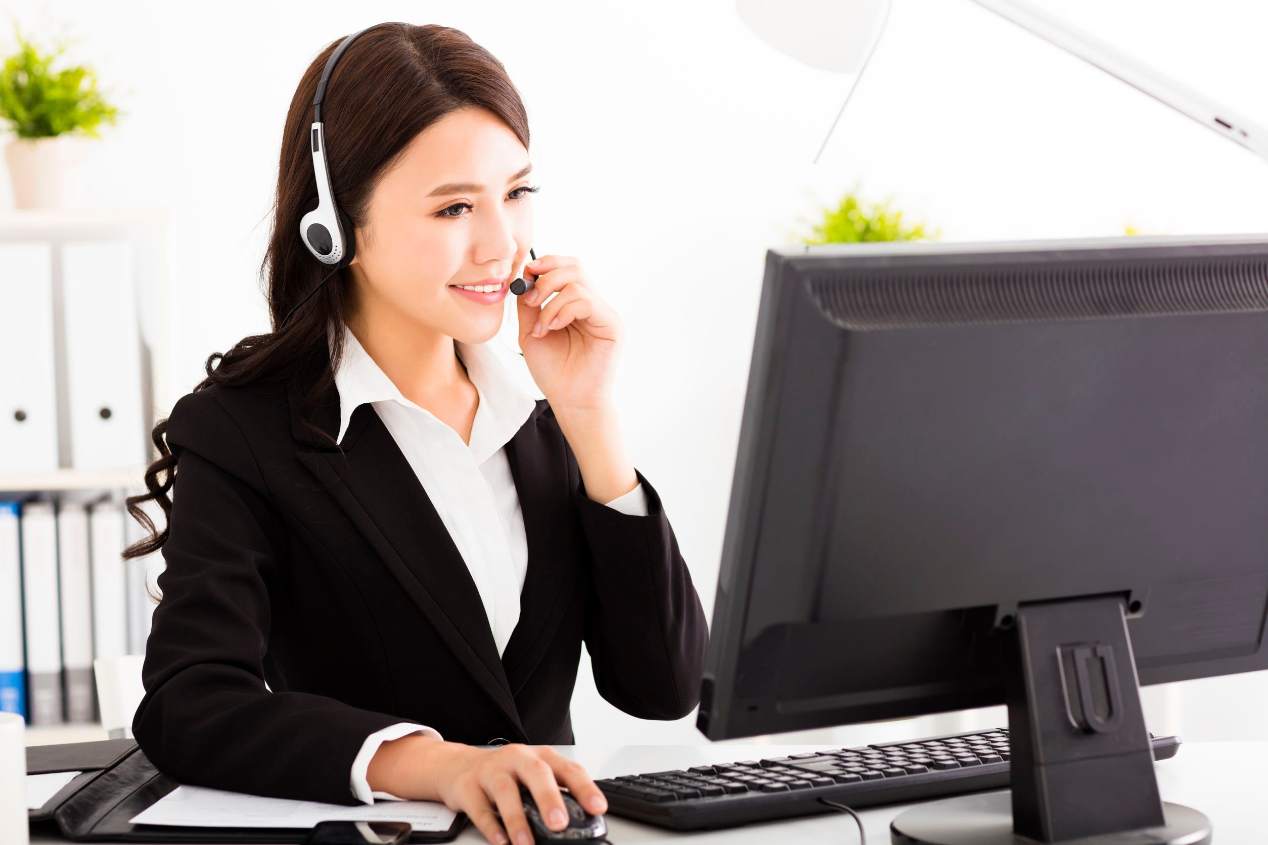 young beautiful business woman with headset in office