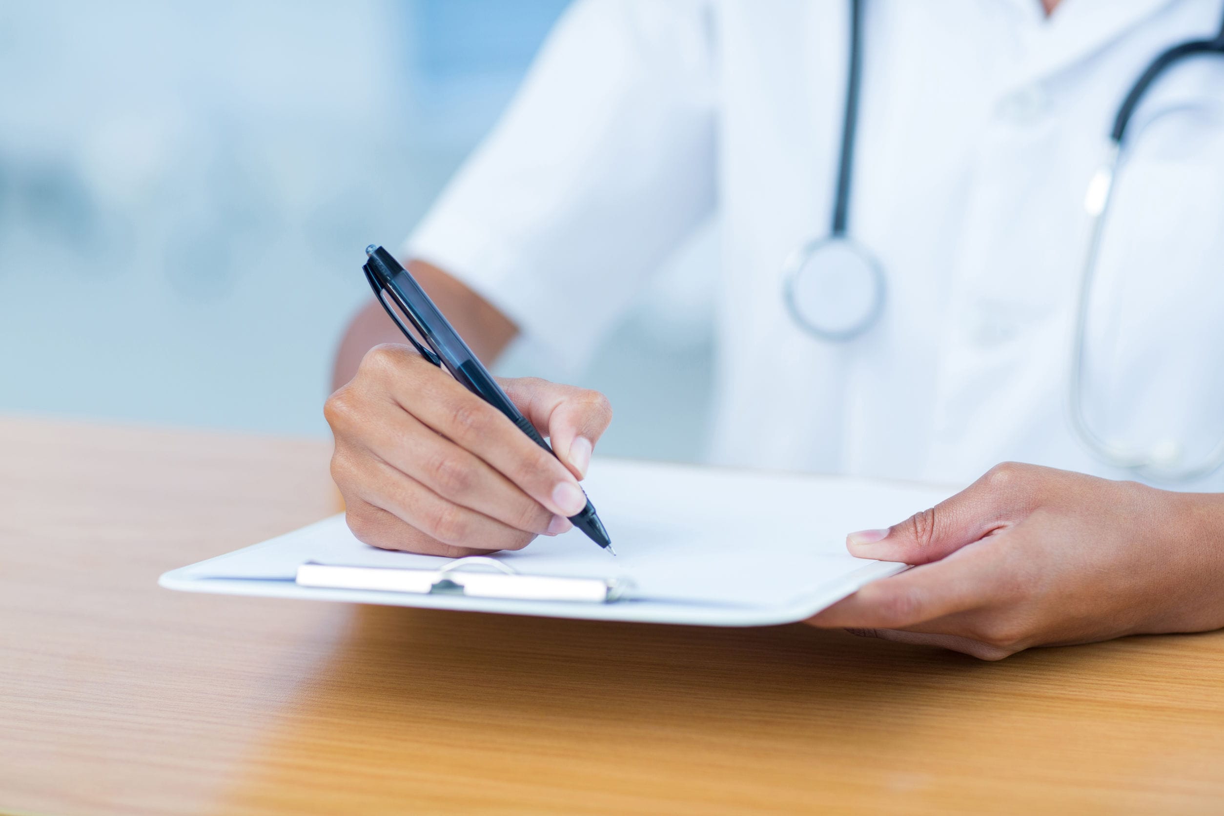 female doctor writing prescription